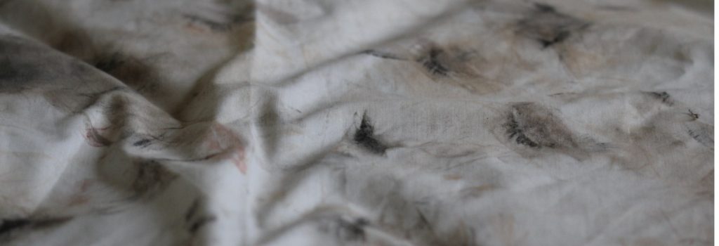 Mark-making using the sheet from my mother's bed. 6 months of my mother's make up worn daily and removed onto her sheet. Smudged colours - muted, with black accents where the mascara and eyeliner made their marks.